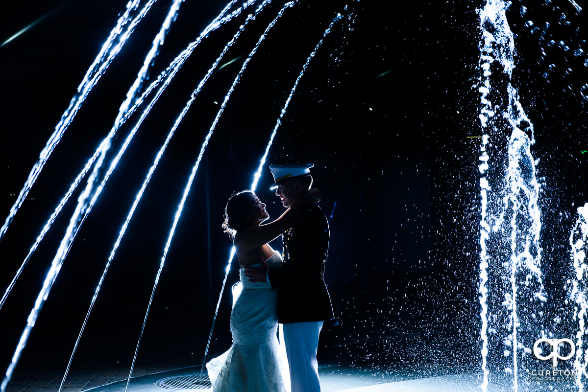 Bride and military groom playing in the fountains after their wedding ceremony at The Commerce Club in Greenville,SC.