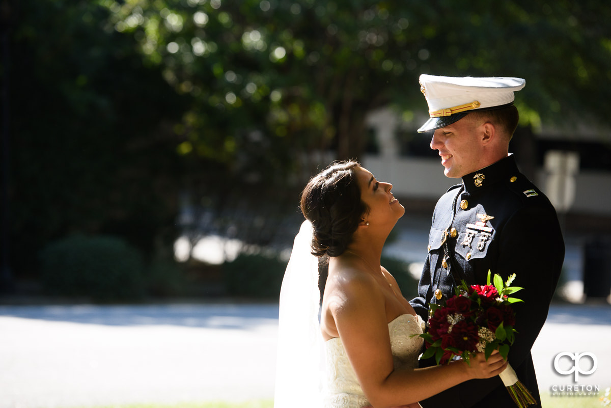 Bride looking at her groom in full dress Marine uniform.