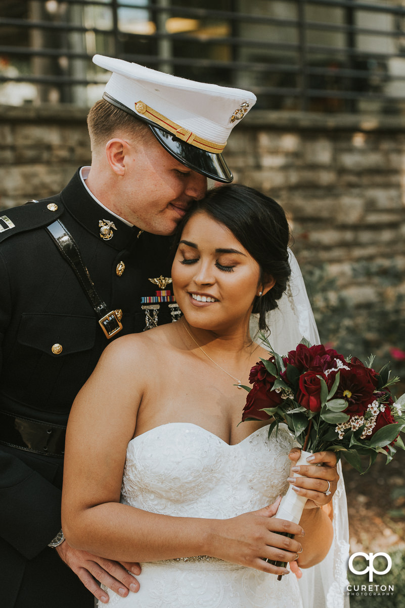 Marine groom and his bride snuggling before their wedding in Greenville,SC.