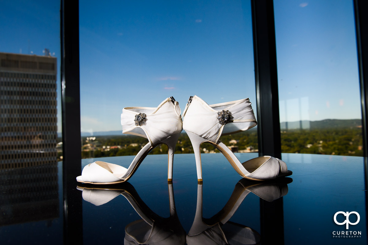 Bride's shoes with a skyline in the background.