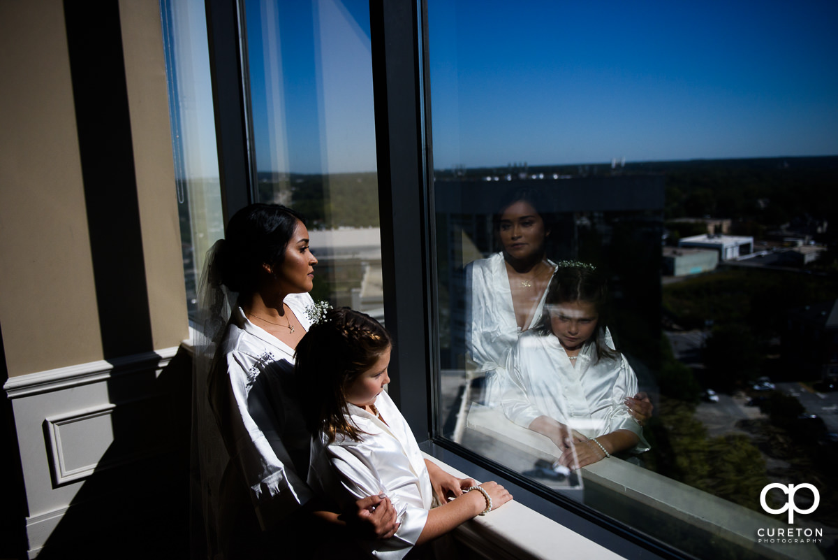 Bride and her daughter looking out the window.