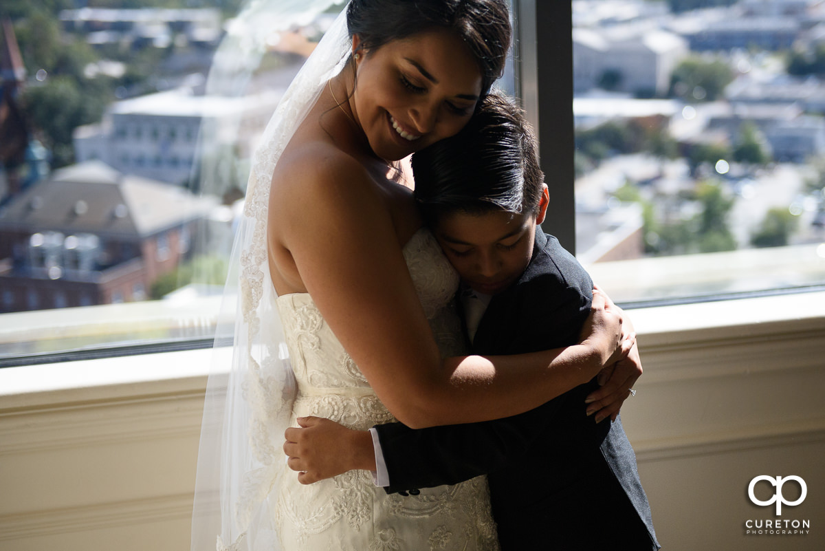 Bride hugging her son before the wedding.