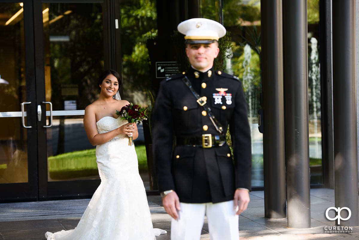 Bride and groom sharing a first look in front of The Commerce Club before the wedding.