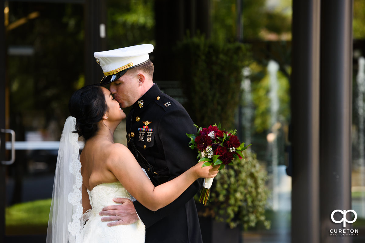 Groom in Marine dress uniform having a first look with his bride in downtown Greenville,SC.