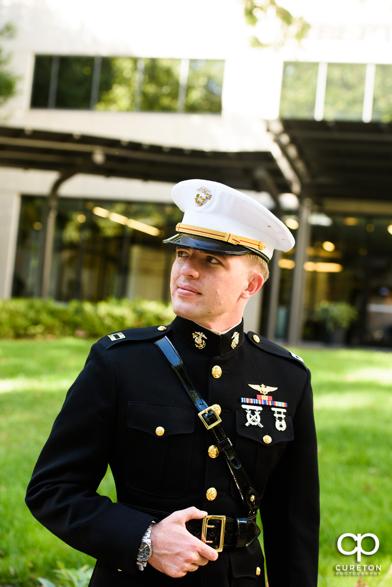 Groom in military uniform in front of the Commerce Club.