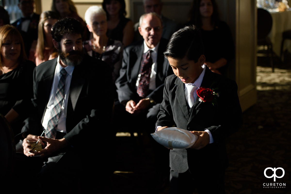 Ring bearer walking down the aisle.