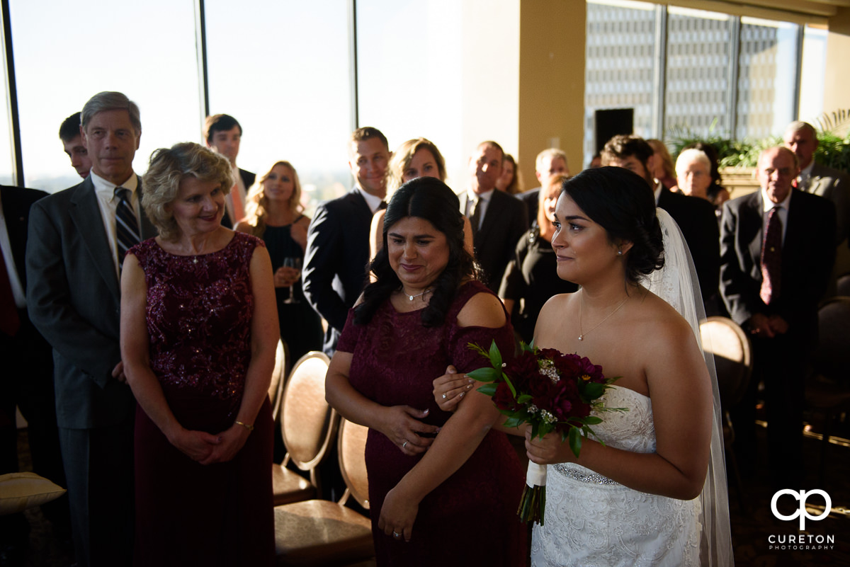 Bride being walked down the aisle my her mother.