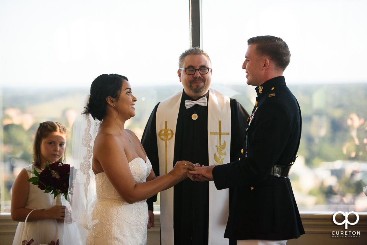 Bride and groom holding hands during the ceremony.