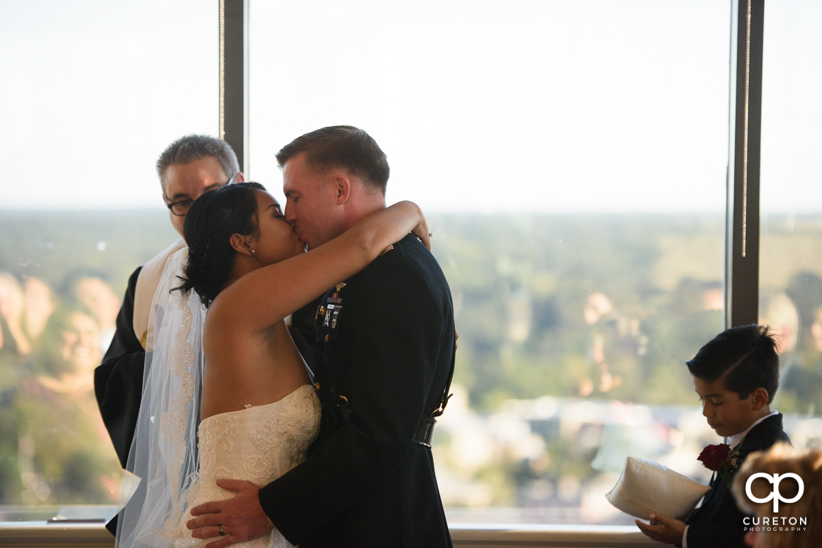 Bride and groom first kiss.