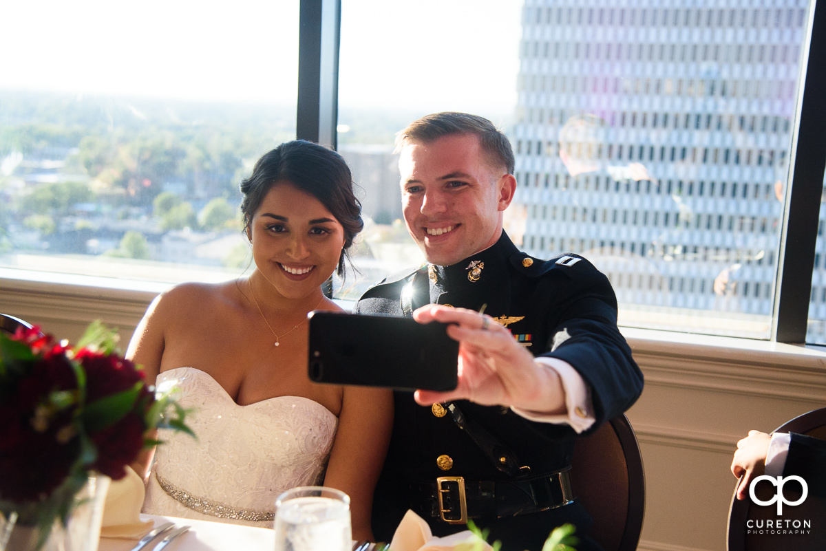 Bride and groom taking a selfie.