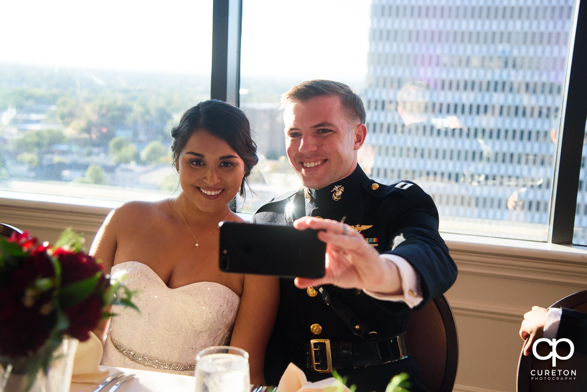 Bride and groom taking a selfie.