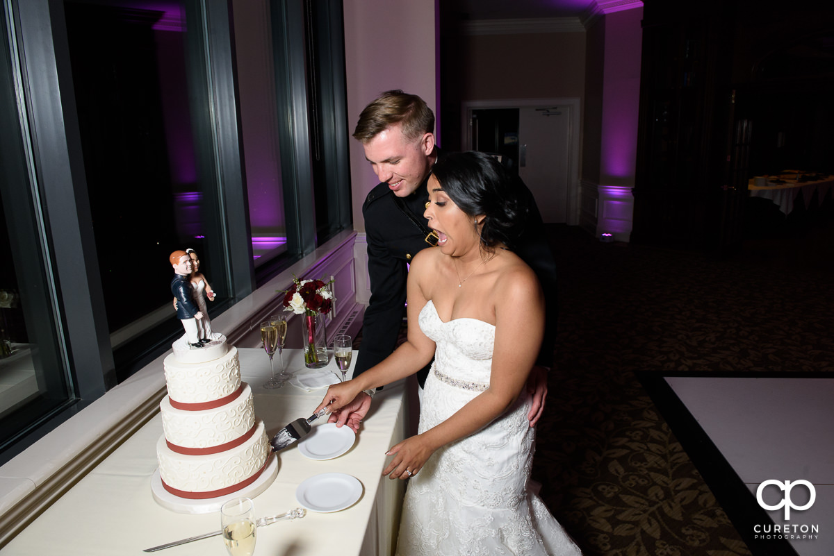 Bride and groom cutting the cake at the reception.