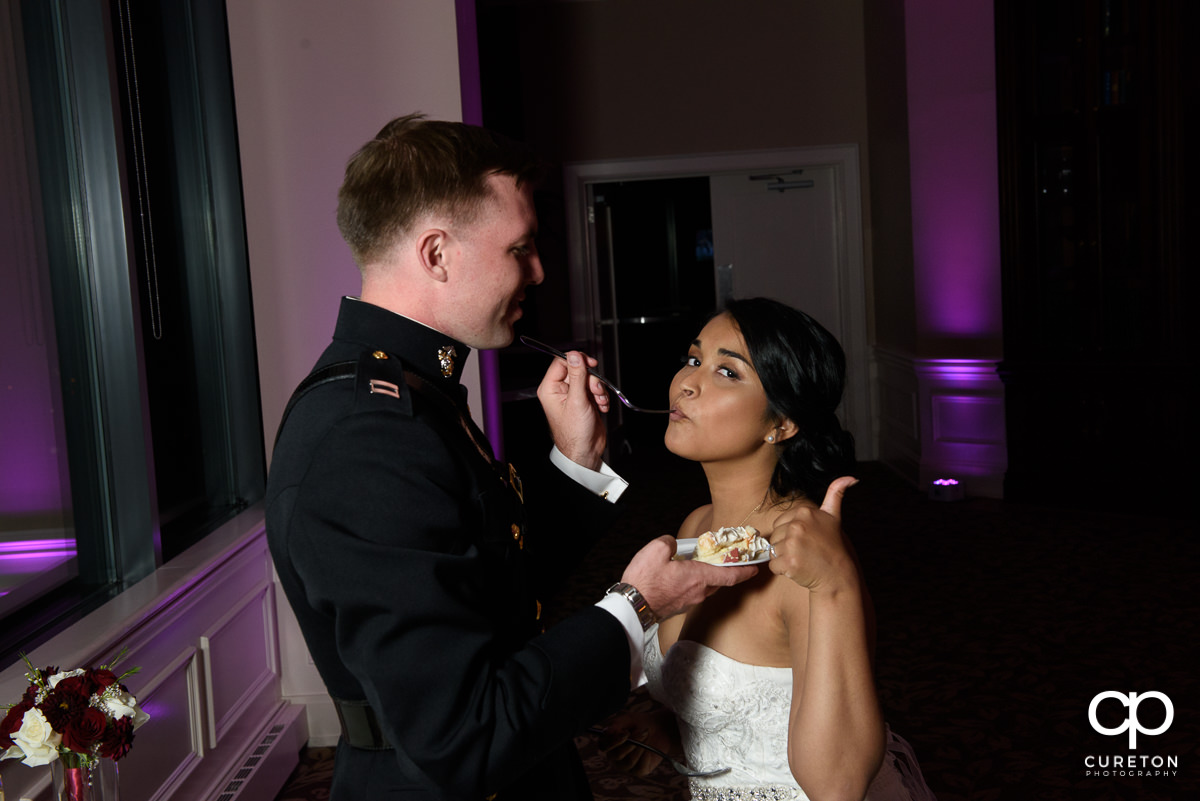 Bride giving the thumbs up at her cake from Couture Cakes in Greenville.