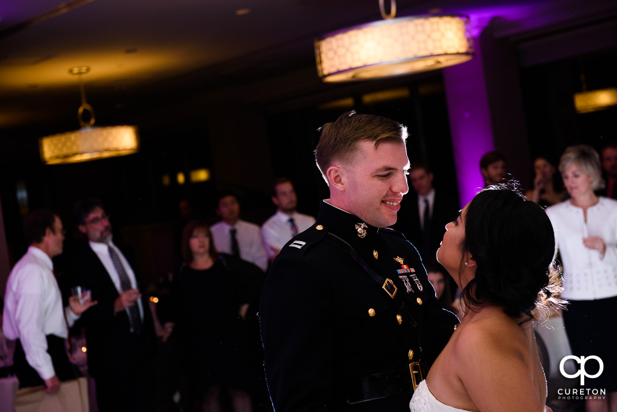 Groom smiling at his bride during their first dance.