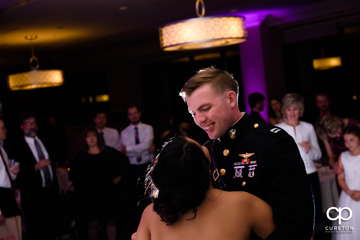 Groom smiling at his bride during the first dance.