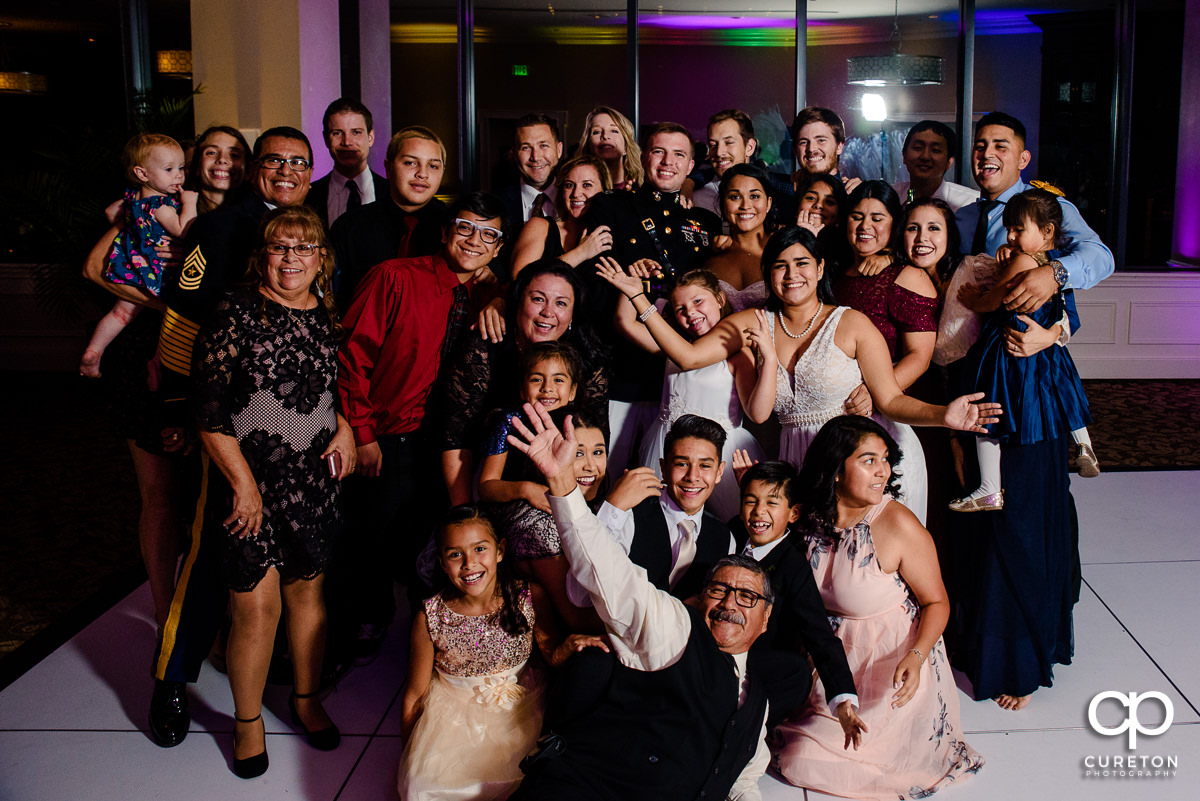 Wedding guests posing on the dance floor.