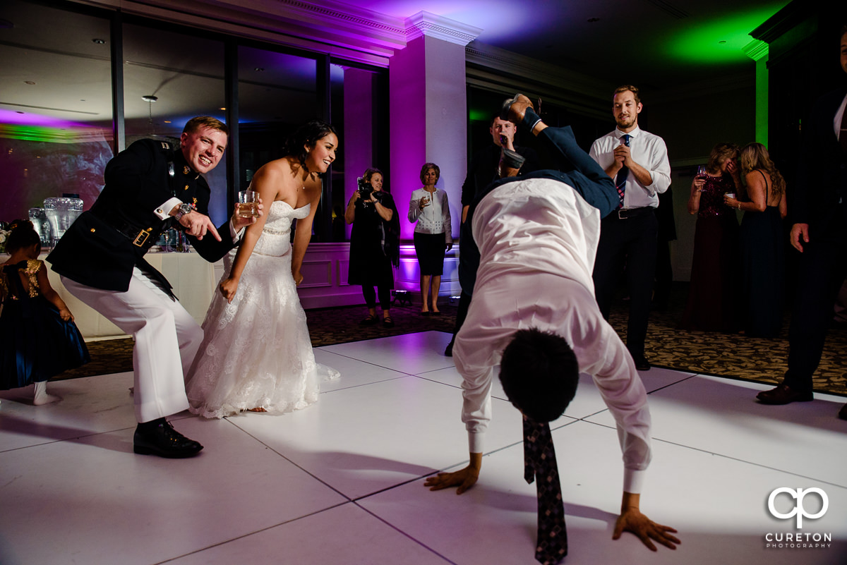 Wedding guests break dancing.