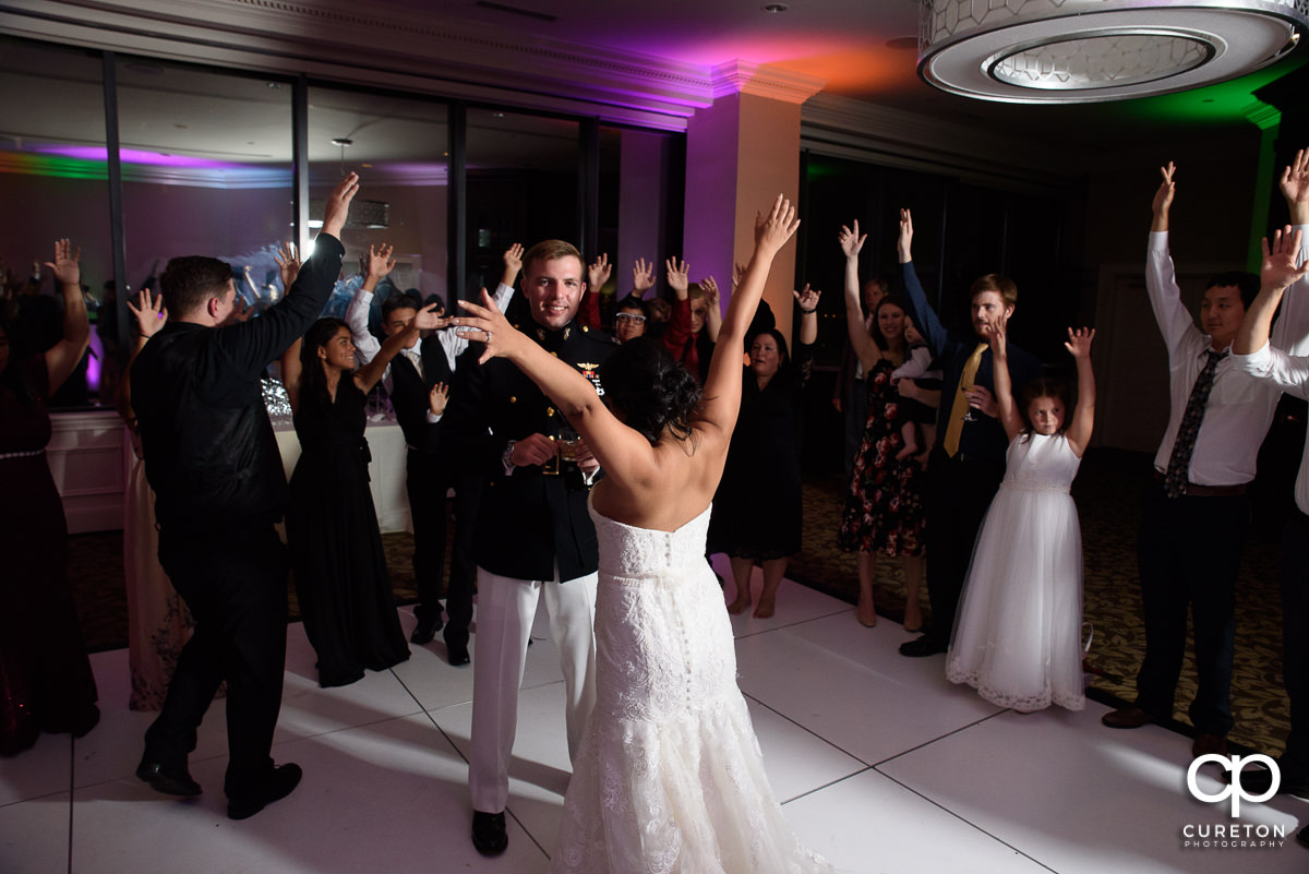Guests dancing with their hands in the air.