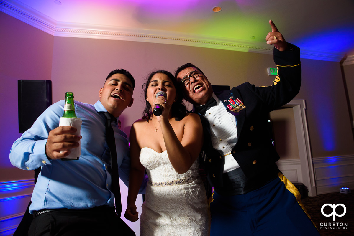 Bride and guests singing in the microphone.