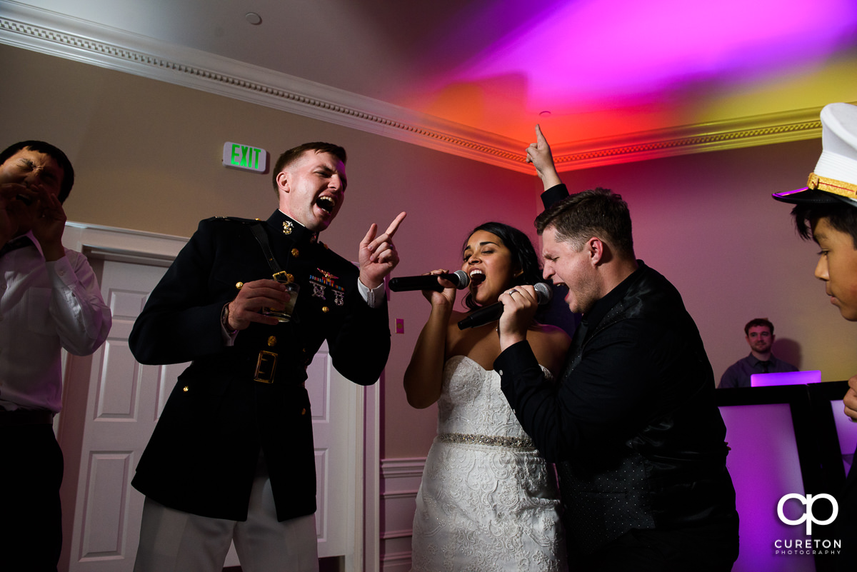 Bride and groom singing with Jumping Jukebox at their Commerce Club wedding reception.