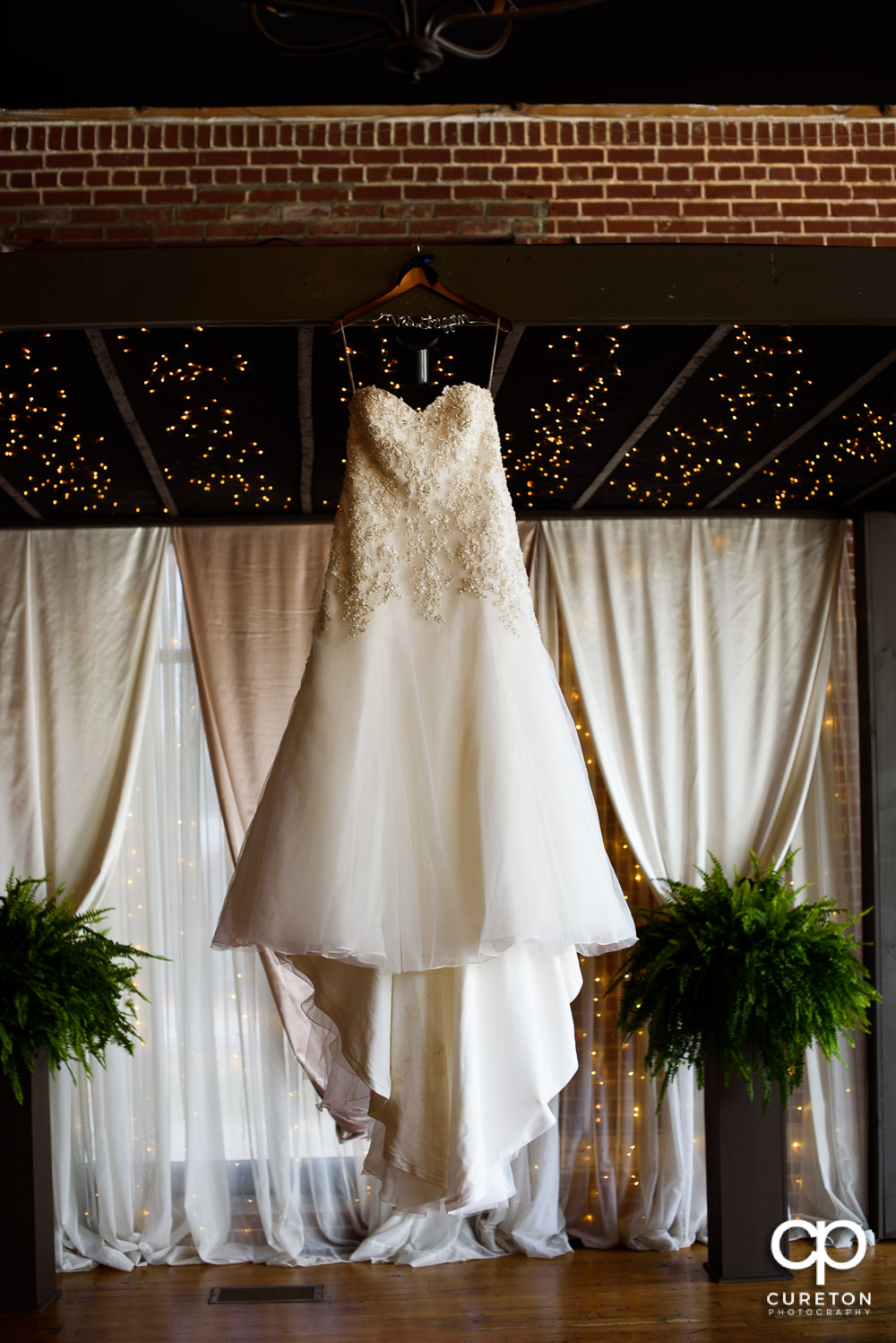 Bride's dress hanging on the alter.