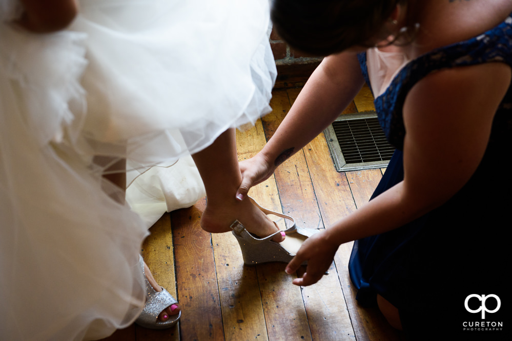 Bride putting on her shoes.