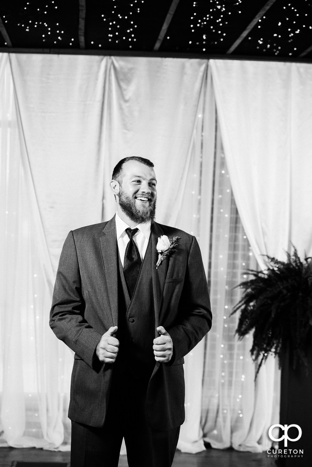 Groom standing at the alter.