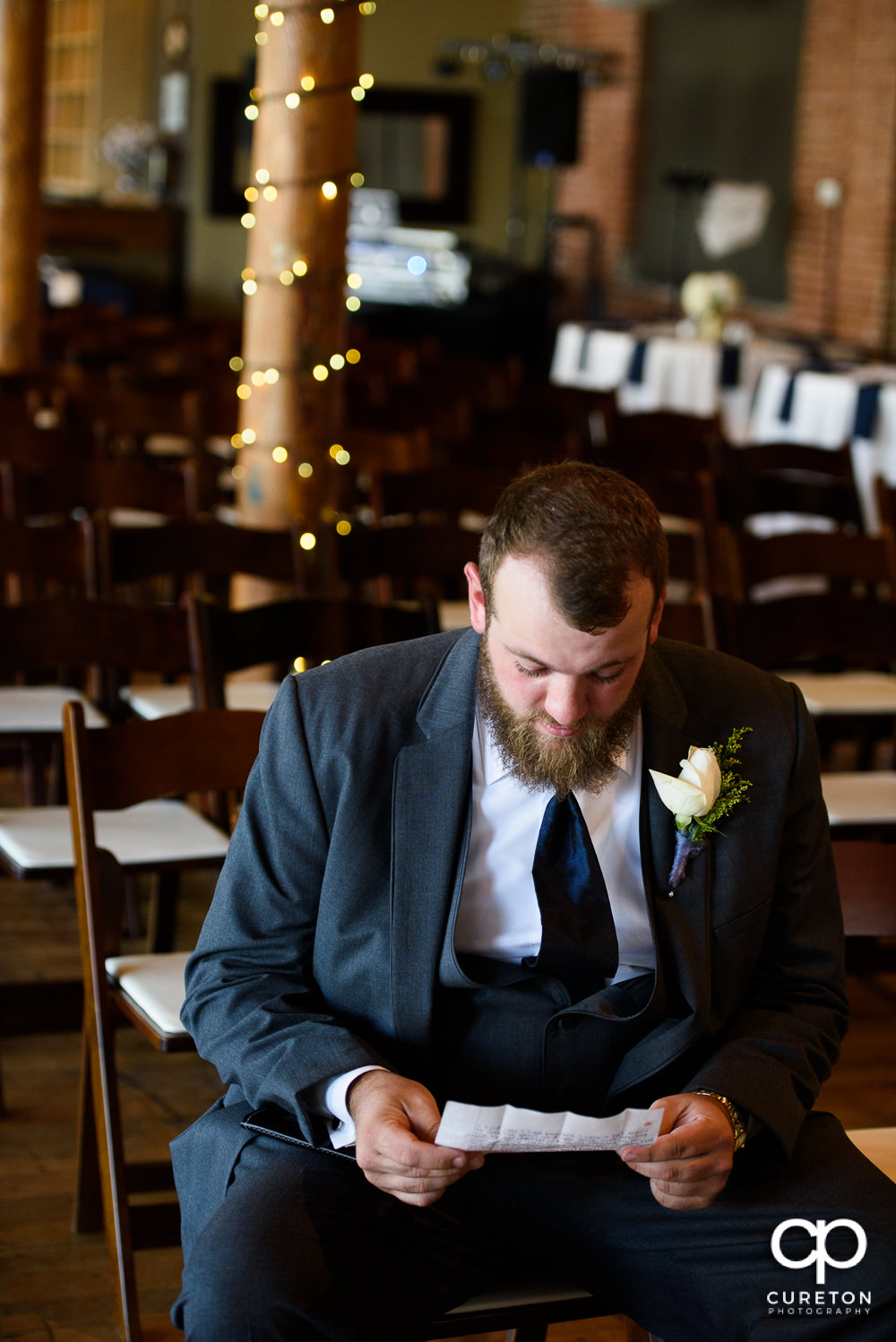Groom reading a pre-wedding note from his bride.