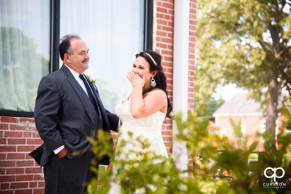 Bride and her father having a first look before the wedding ceremony.