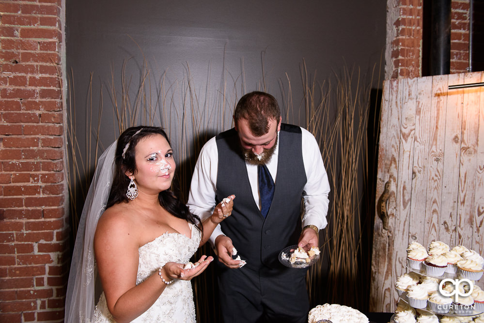 Bride and groom cutting the cake at the reception.
