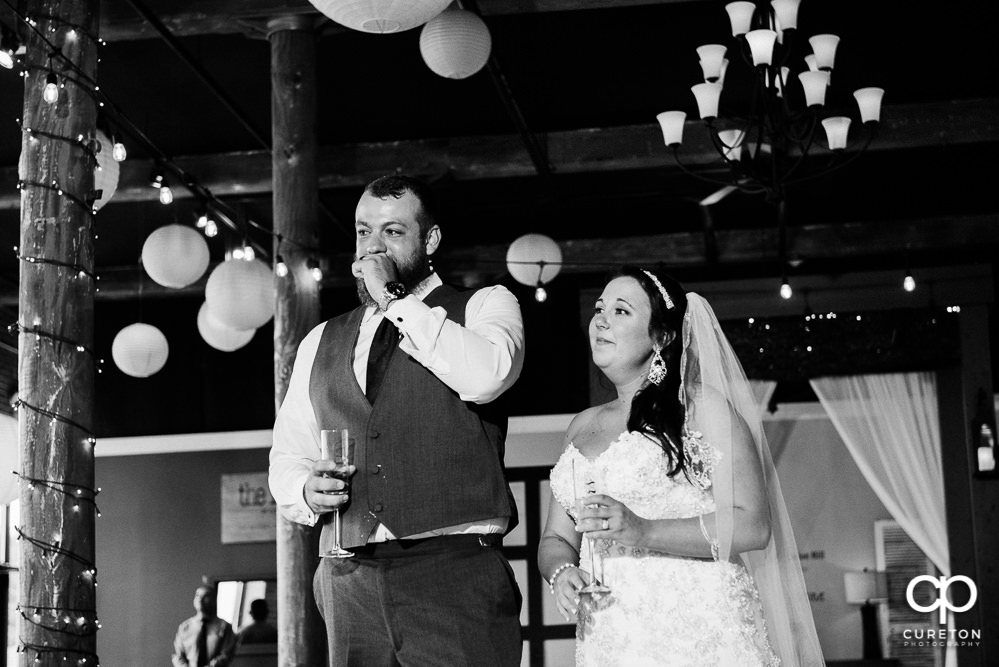 The best man and maid of honor giving toasts at the reception.
