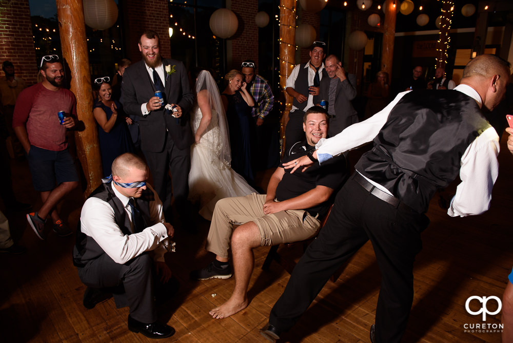Person who caught the garter putting it on the person who caught the bouquet.