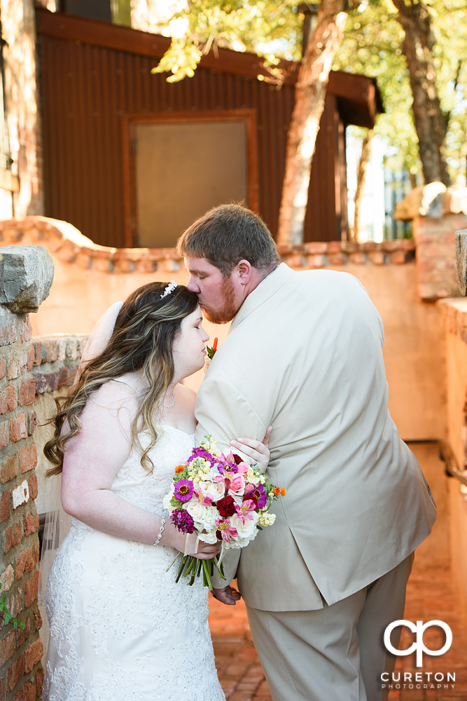 Bride and groom outside in the courtyard before their wedding reception at The Old Cigar Warehouse.