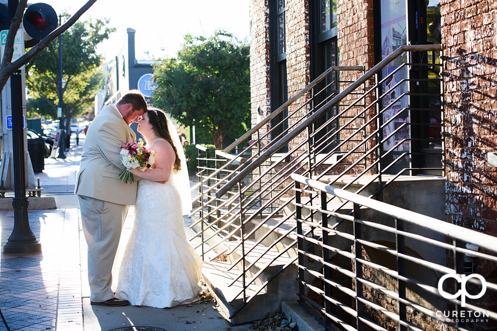 Married couple on the sidewalk downtown.