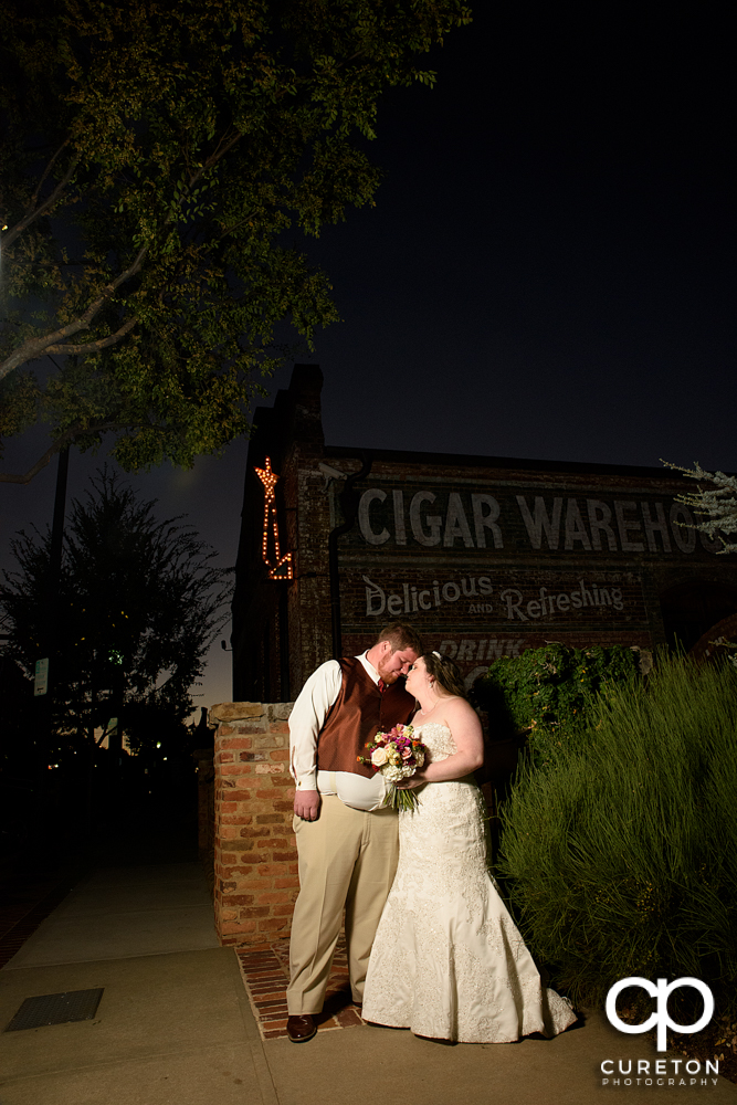 Bride and groom at dusk during their wedding reception at The Old Cigar Warehouse.