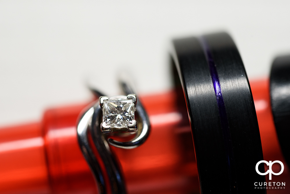 Wedding ring on a mini lightsaber.