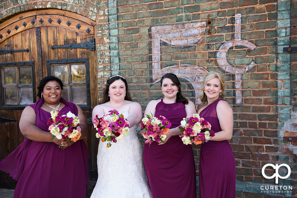 Bride and Bridesmaids standing on the deck of the Old Cigar Warehouse.