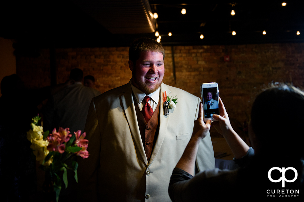 Groom getting his boutonniere pinned.