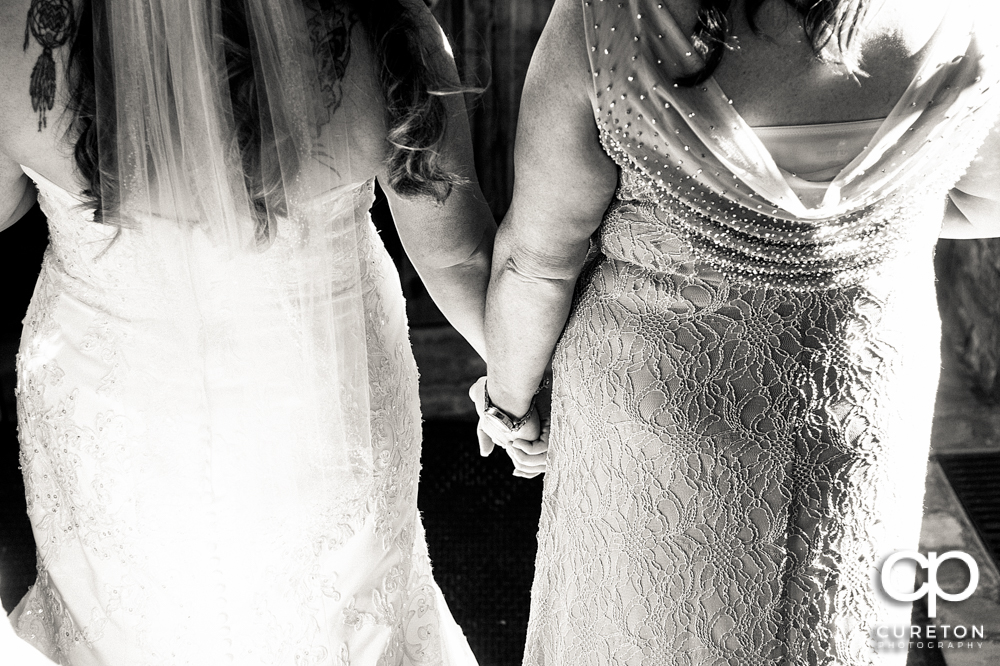 Bride and mom getting ready to walk down the aisle.