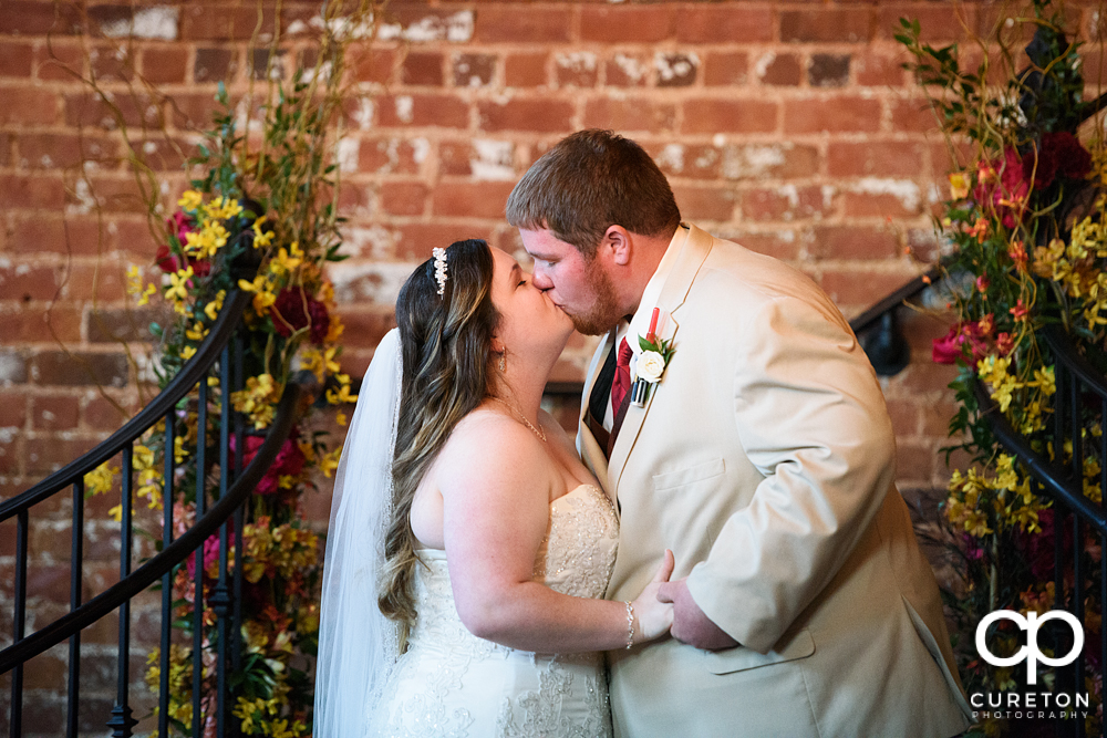 Bride and groom first kiss.