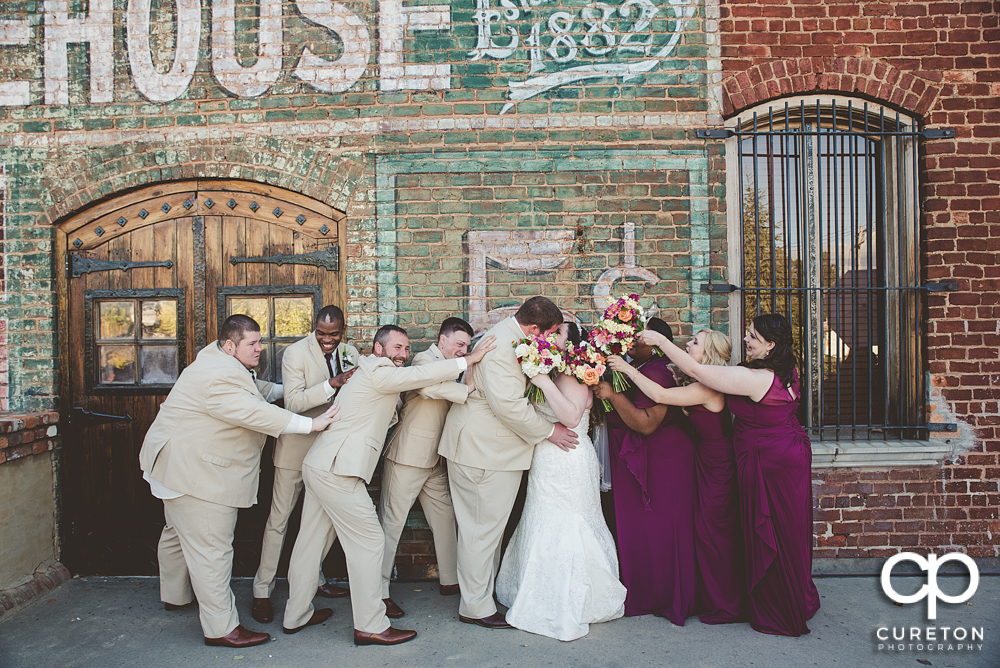 Creative wedding party pose on the deck at The Old Cigar Warehouse in Greenville,SC.
