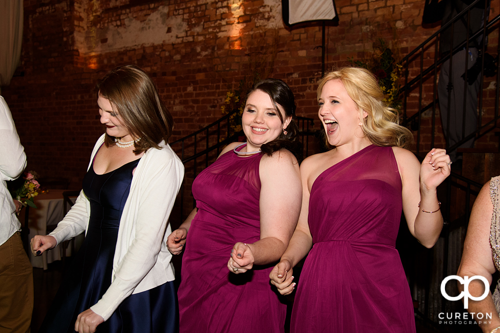 Bridesmaids dancing at the reception.