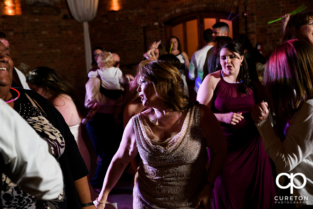 Wedding guests dancing to the sounds of Uptown Entertainment.