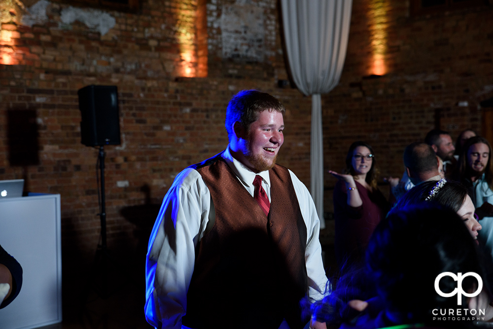 Groom smiling at the reception.