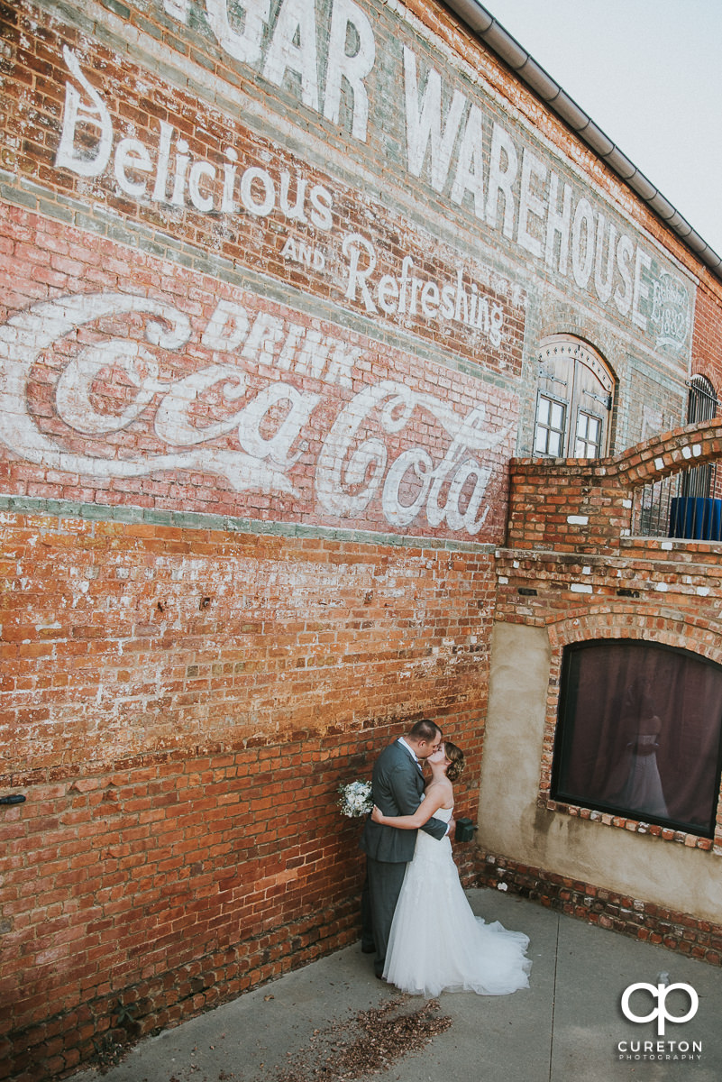 Bride and groom kissing at The Old Cigar Warehouse.