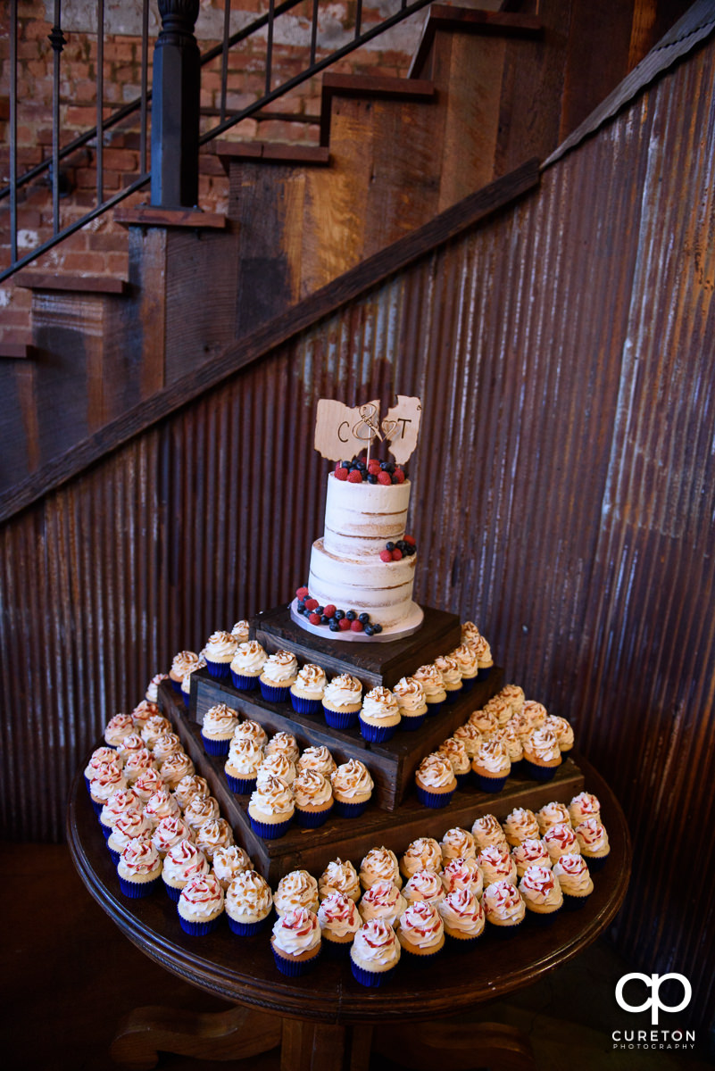 Wedding cake and cupcake display by Buttercream Bakehouse at The Old Cigar Warehouse.
