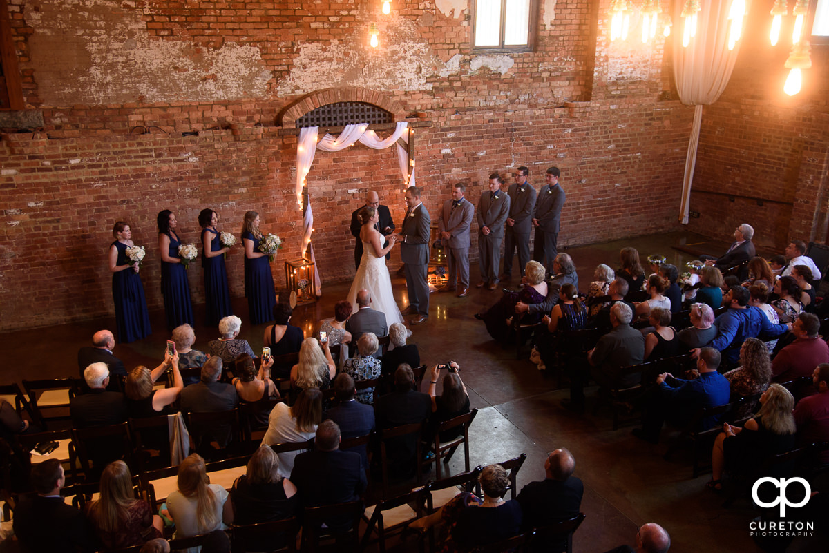 Wedding ceremony in the main hall at The Old Cigar Warehouse.