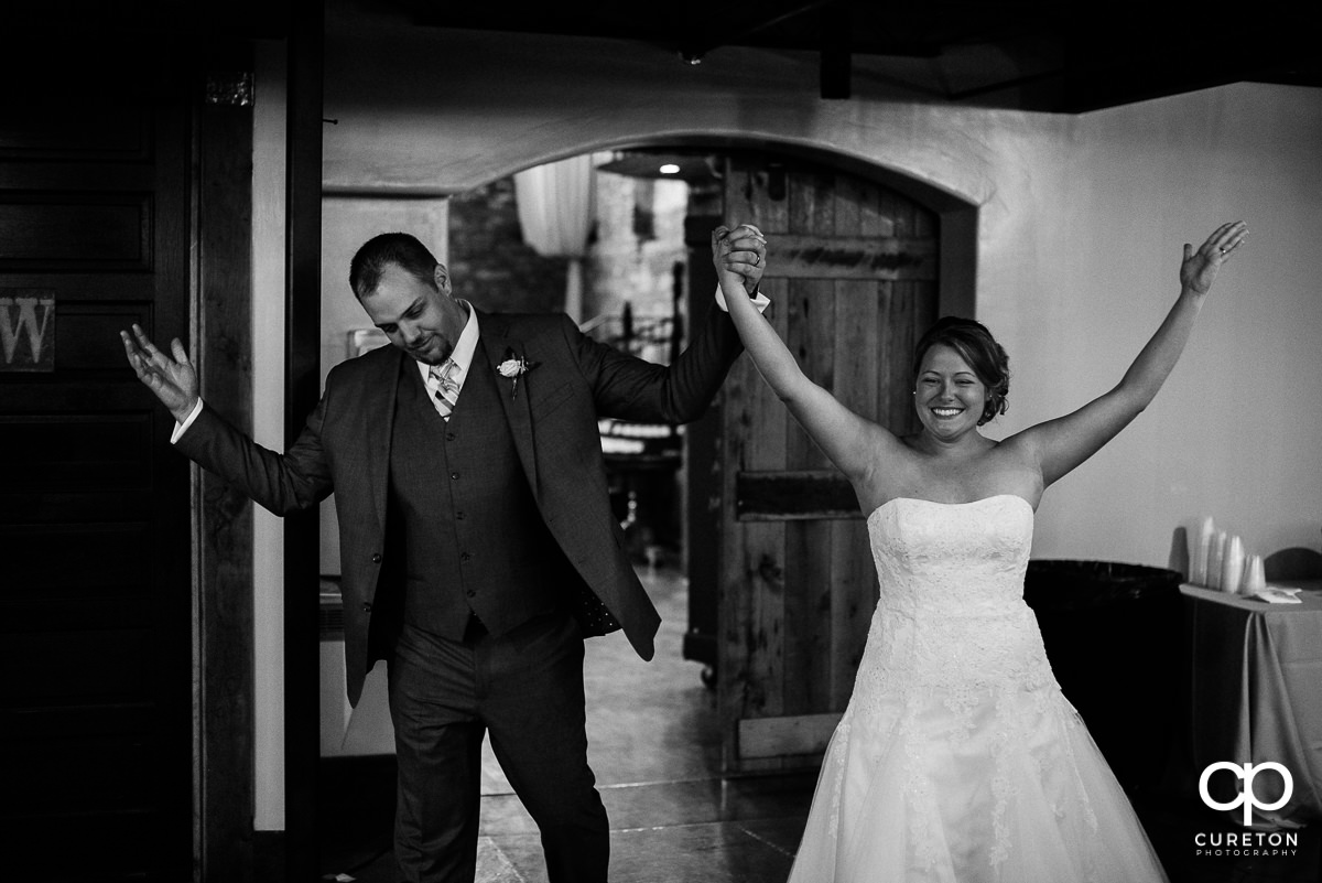 Bride and Groom making an entrance into the reception.