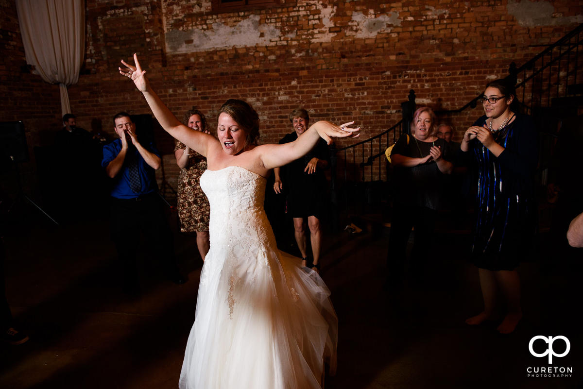Bride dancing during her reception at The Old Cigar Warehouse.