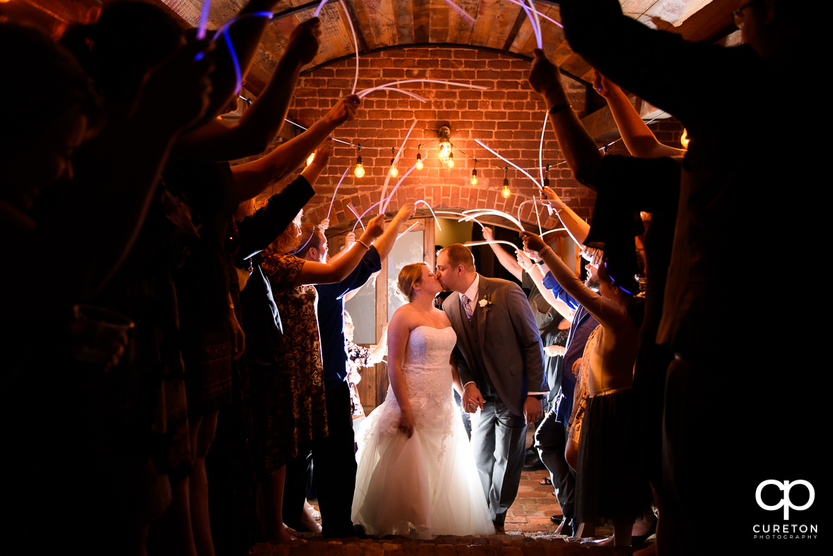 Bride and Groom making an epic grand exit through glow sticks at The Old Cigar Warehouse in downtown Greenville.